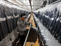 Frank Gomes checks for sizing accuracy before the suits are shipped at the Joseph Abboud manufacturing plant in New Bedford, MA.   [ PETER PEREIRA/THE STANDARD-TIMES/SCMG ]